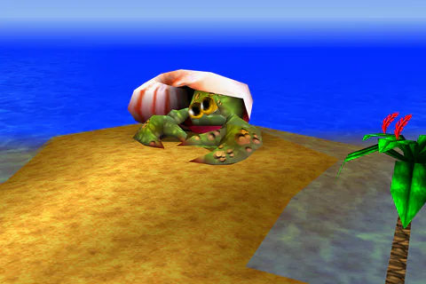 Nipper faces the beach from beneath his pink striped shell