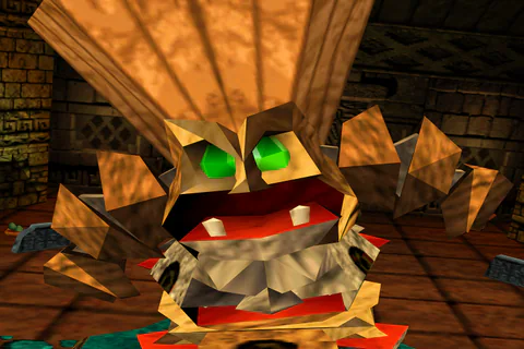 Close view of Targitzan’s green eyes, red mouth and square teeth