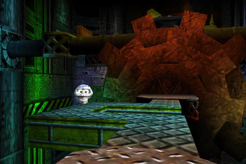 A Mumbo Token on a metal platform beside a large rusty gear
