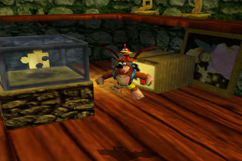 Banjo beside a Jiggy displayed inside a glass case in a wooden room.