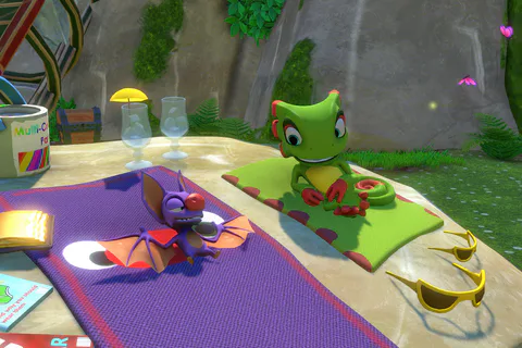 Yooka and Laylee sunbathing beside their ship in Shipwreck Creek.