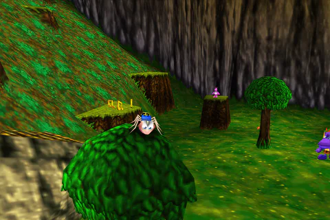 Termite Banjo stands on a green bush beside a slope in Mumbo’s Mountain.