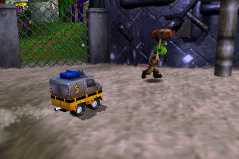 Van Banjo drives near a Witchyworld worker beside the metal fence.