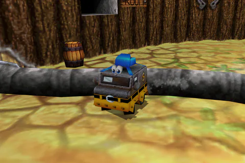 Van Banjo stands on sandy ground below wooden ledges in the Western Zone.